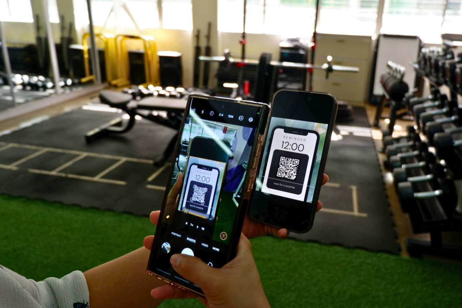An Android phone scanning a QR code shown on an iPhone screen