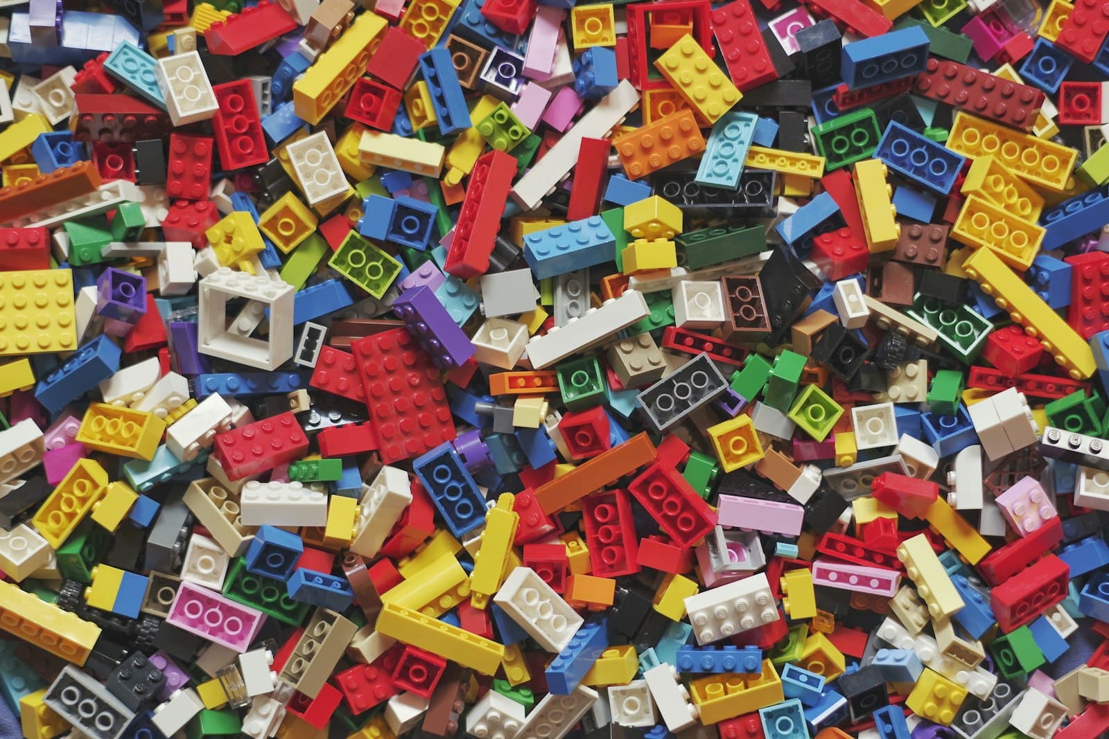 Hundreds of colourful plastic building bricks mixed together